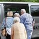 Elderly people stepping into the Bang Bus.